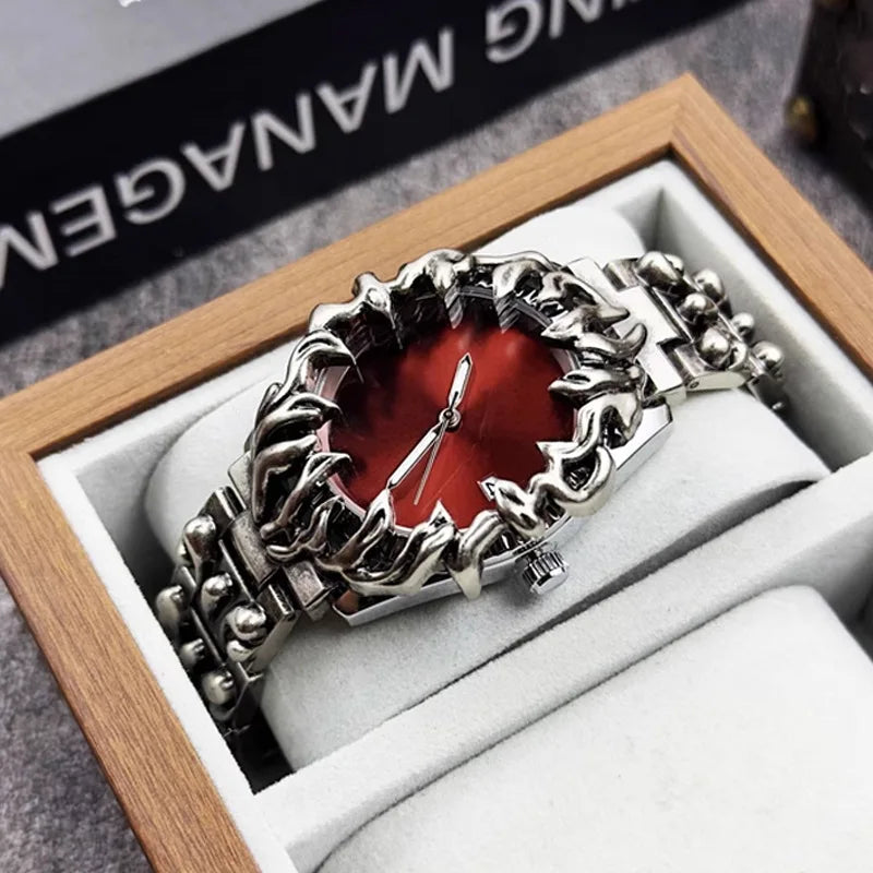 metal wristwatch with flame-shaped silver bezel and red dial, displayed in a wooden box